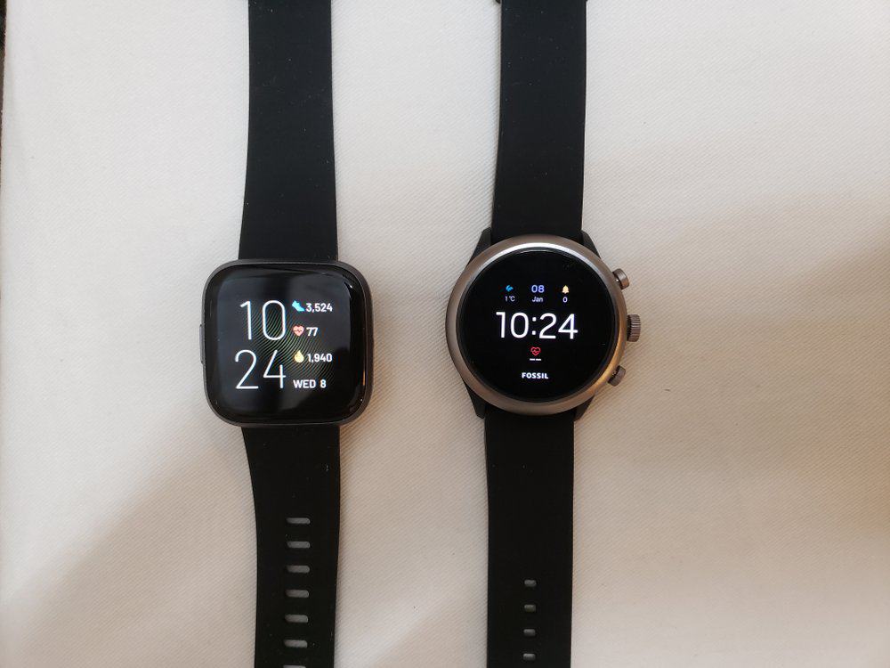 Fitbit Versa 2 on left, Fossil Sport Smartwatch on right
