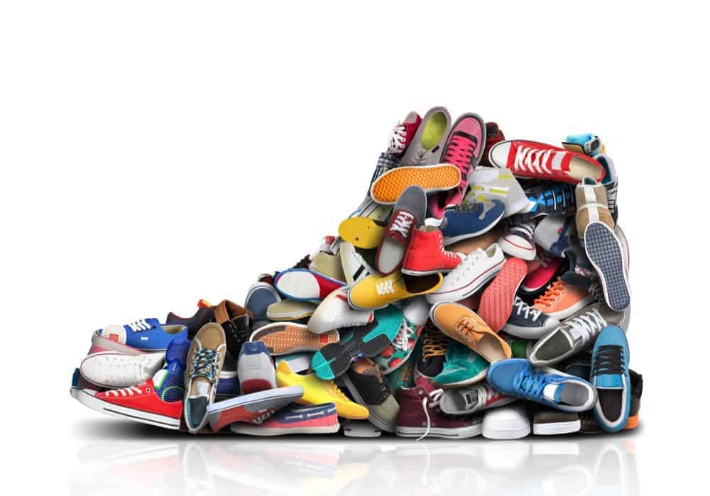 A pile of sneakers make a collage of a sneaker.