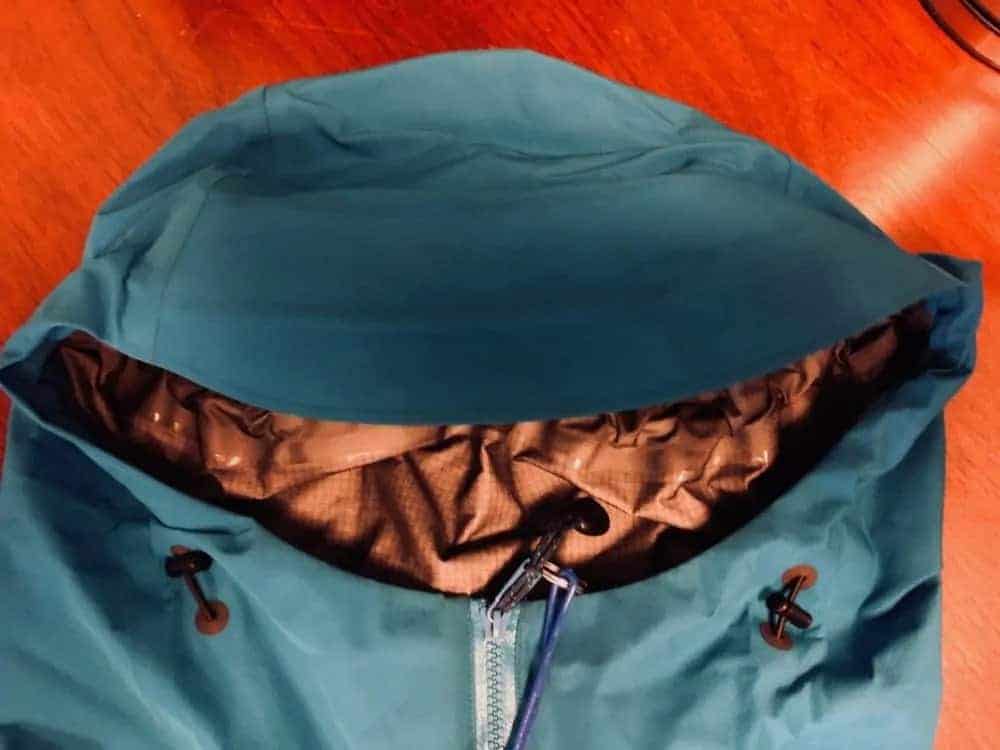 Front view of hood of Arcâ€™Teryx Beta LT jacket. Hood adjustments to left and right of zipper.