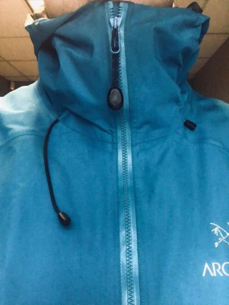 Close-up front view of zipped up Arcâ€™Teryx Beta LT jacket. Notice the extensive neck protection when zipped up.