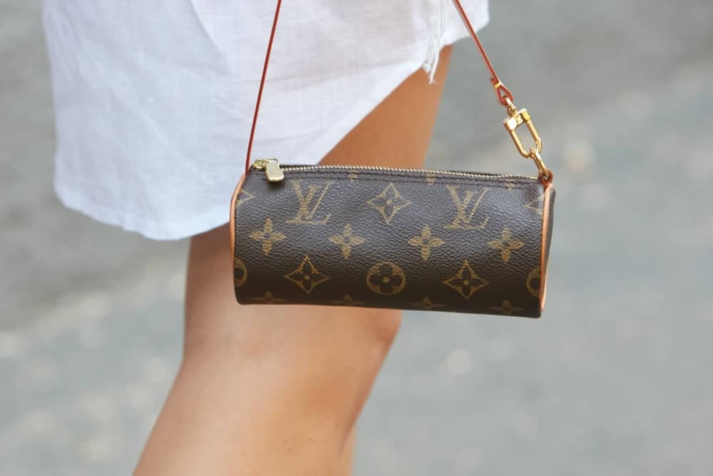Woman with small Louis Vuitton barrel bag.