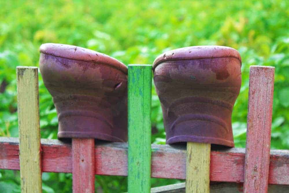 Boots on a wooden fence.