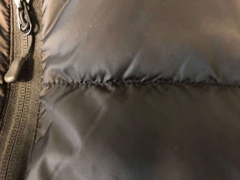 Close up of stitching on Canada Goose puffer down jacket.
