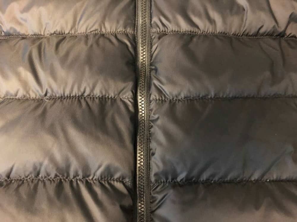 Close up of Canada Goose jacket stitching and zipper.