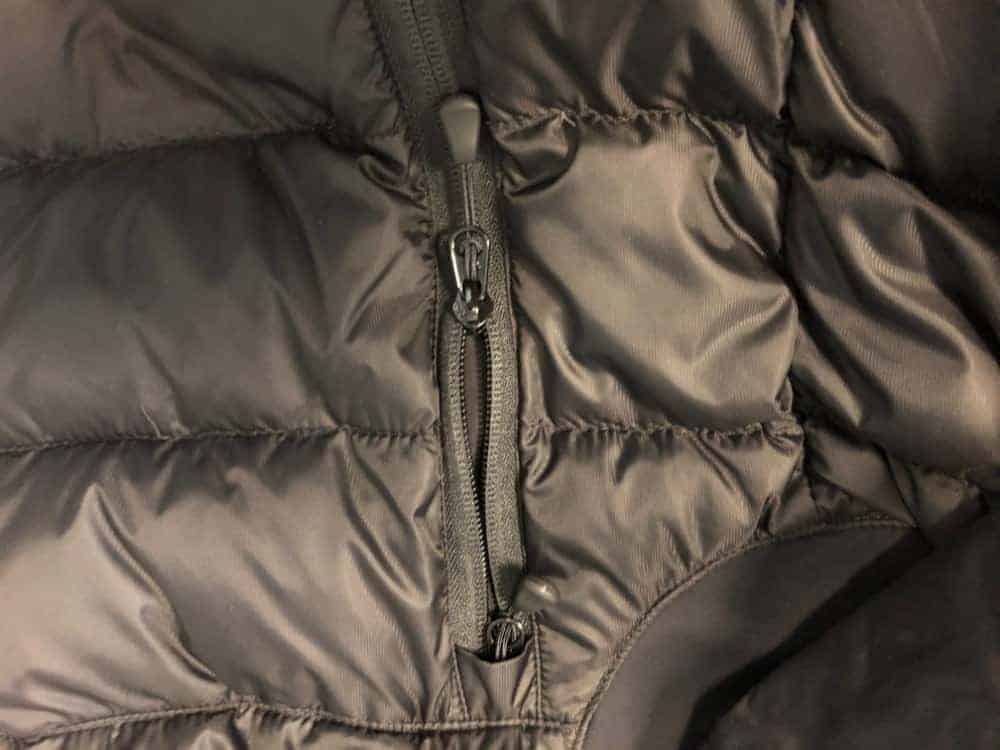 A close up photo of Canada Goose side pocket zipper.