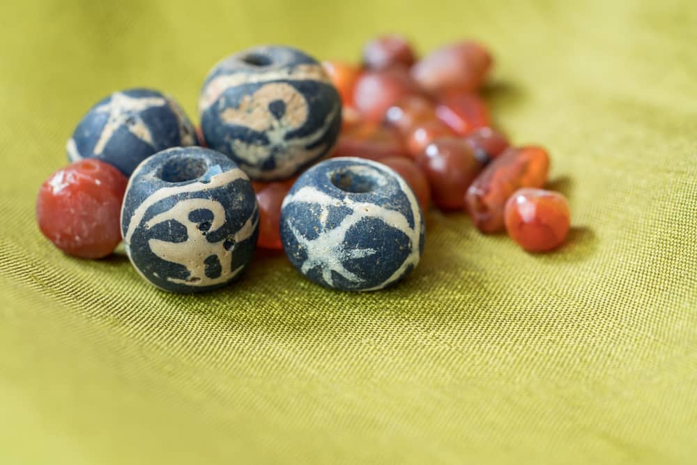 Ancient blue bird glass beads along with ancient carnelian beads.