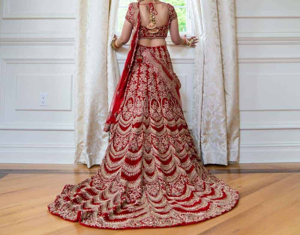 Pakistani Indian bride wearing a wedding lehenga sharara dress.
