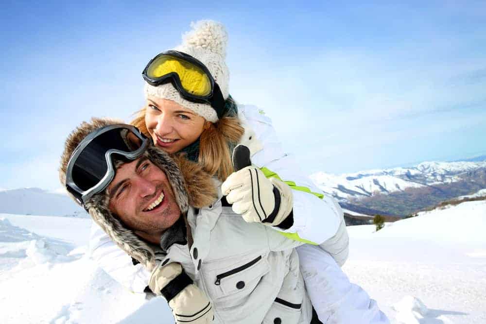 Man and woman wearing gloves in snow