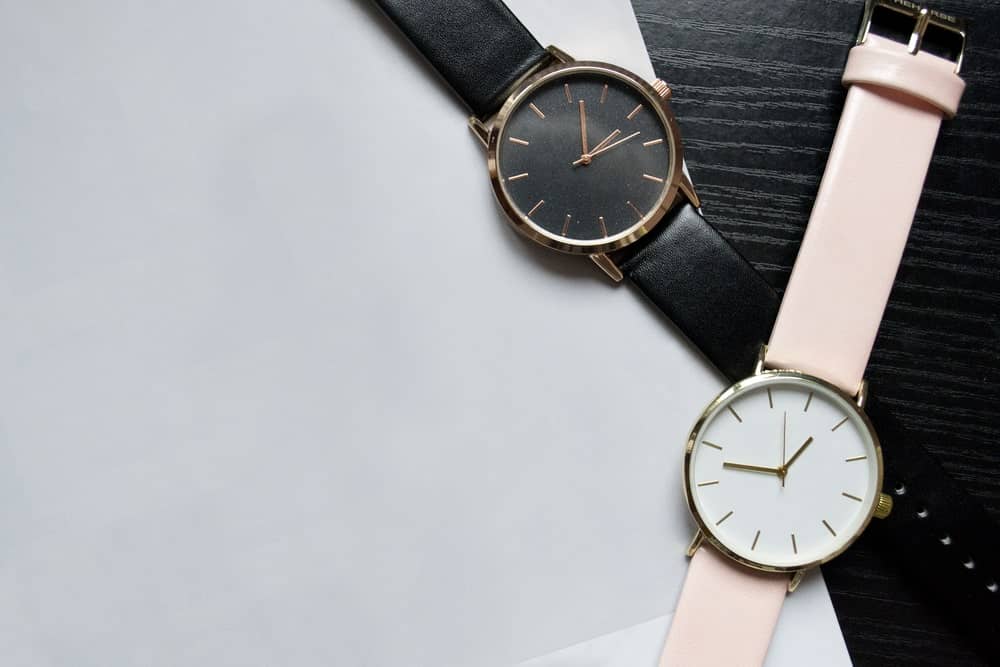 Black and pink analog watches