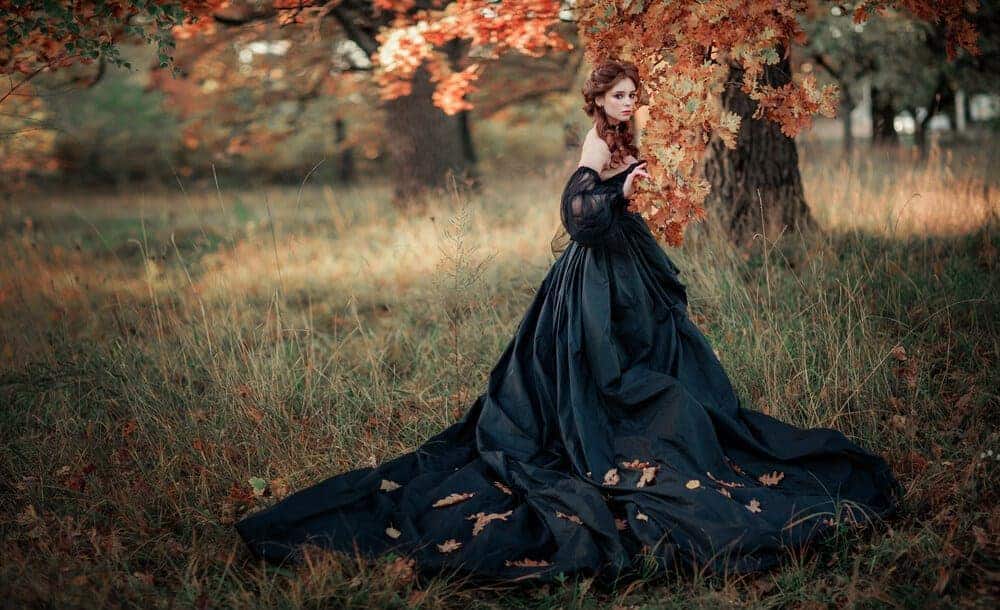 A woman wearing a black gothic gown.
