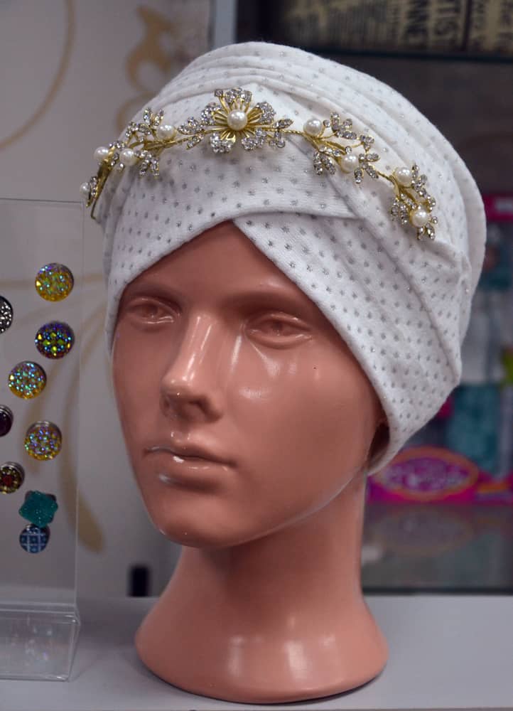 A mannequin head wearing sarpach.