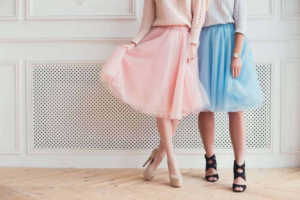 Two girls in tulle skirts and heels.