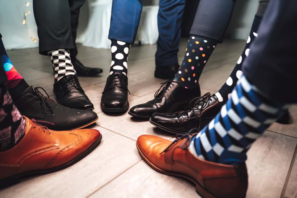 Close up of men legs wearing formal shoes and colorful socks.