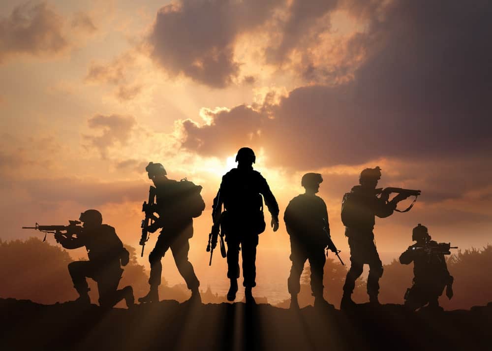 Military silhouettes on sunset.