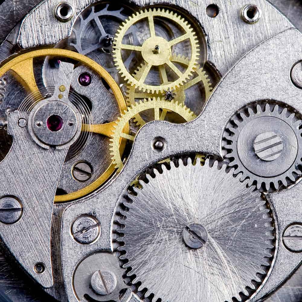 Closeup of a clockwork with gears, spring, steel, and brass.