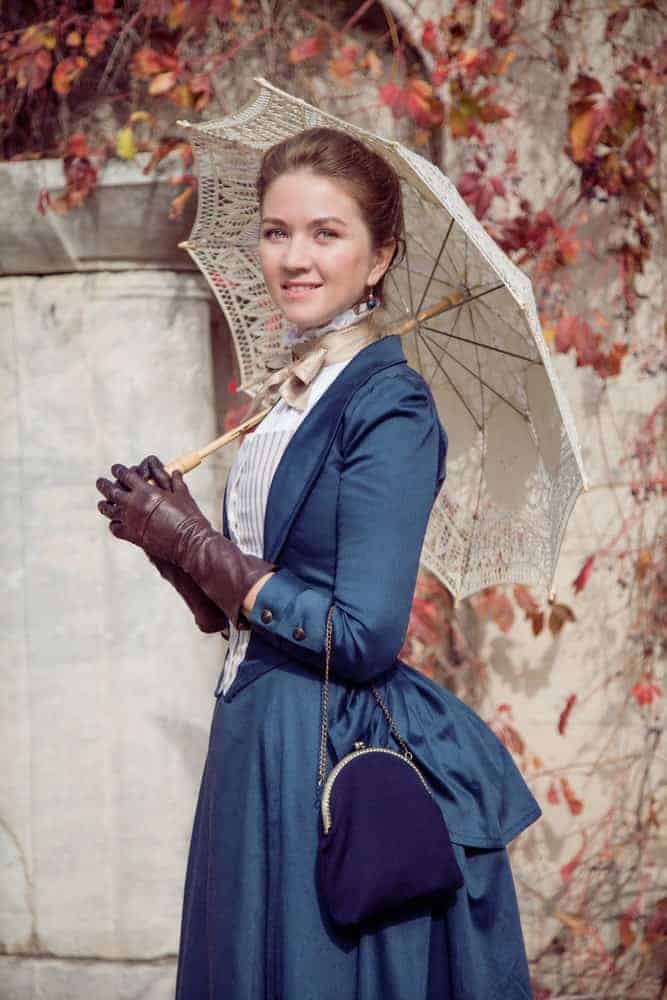 Lady in Victorian style with blue purse.