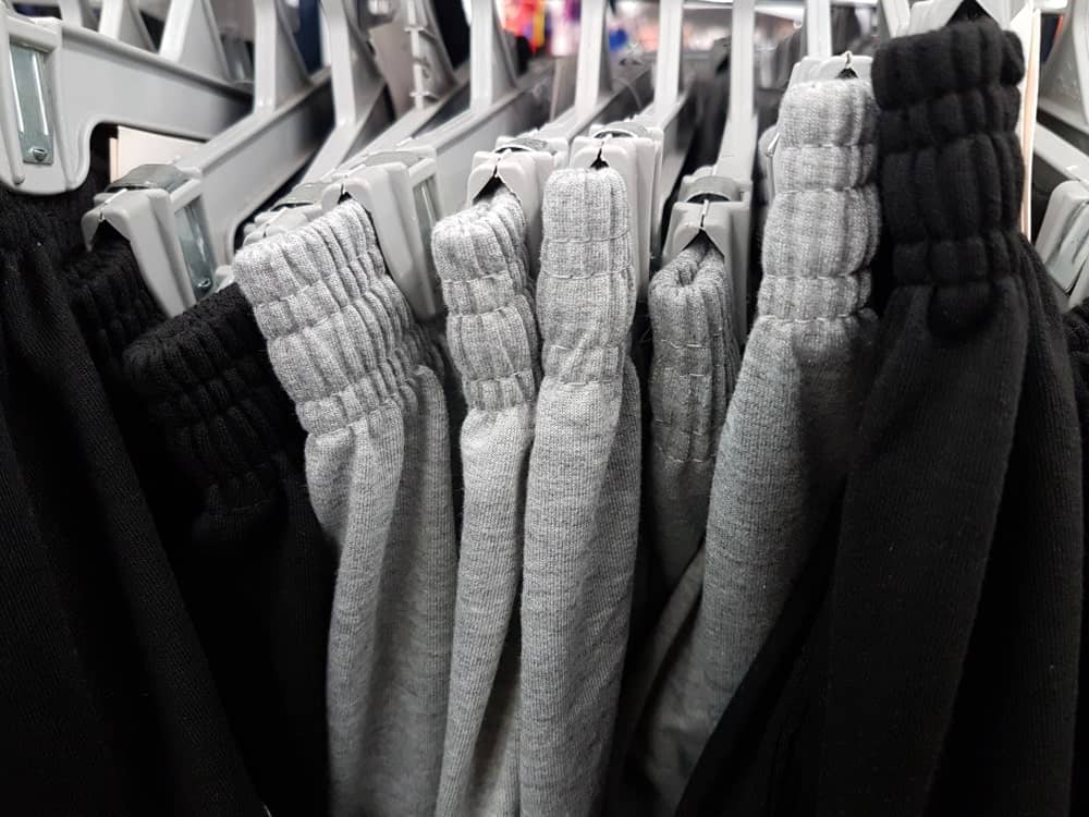 Gray and black sweatpants on display at a shop.