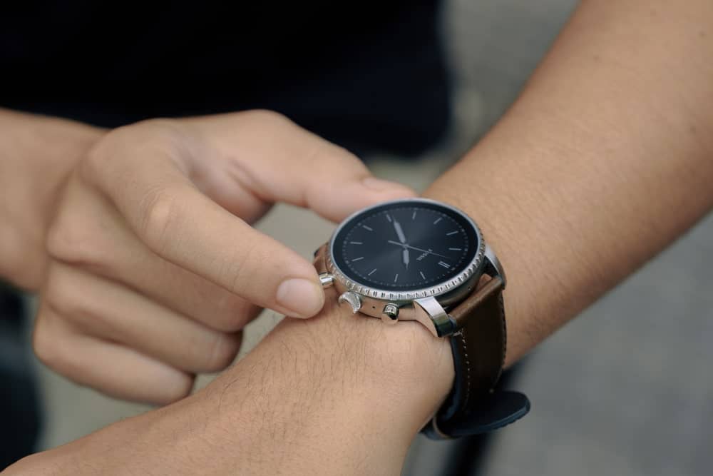 A close look at a man sporting a Fossil smartwatch.
