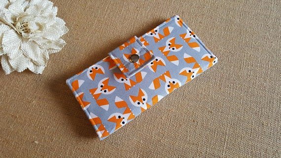 Gray fabric wallet with printed fox cartoons.