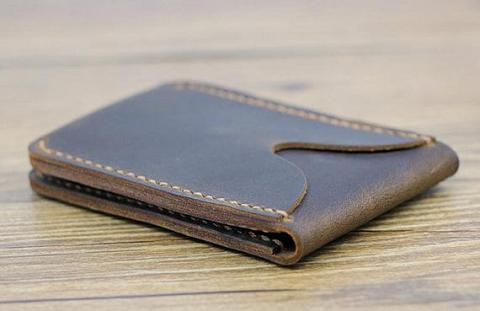 An ID wallet made of dark brown leather.
