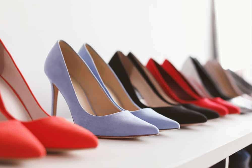 A row of women's high heel shoes on display.