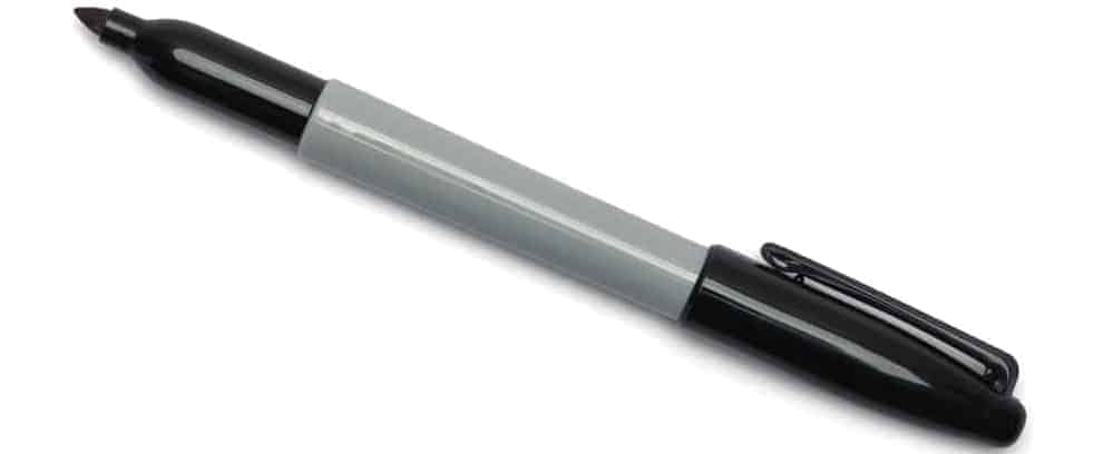 A close look at a black marker pen with its cap off.
