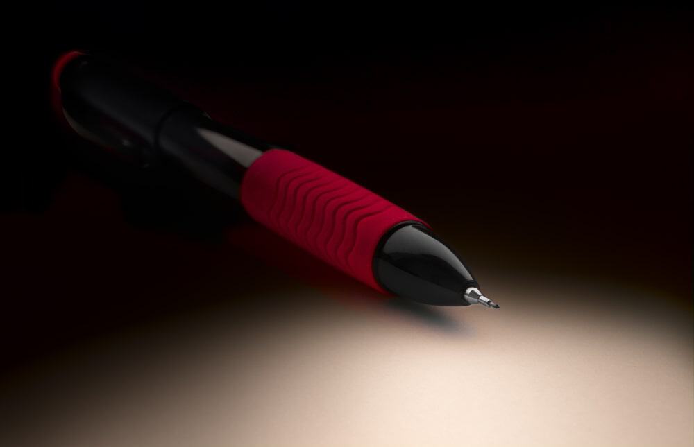 A close look at a red and black soft-grip pen.