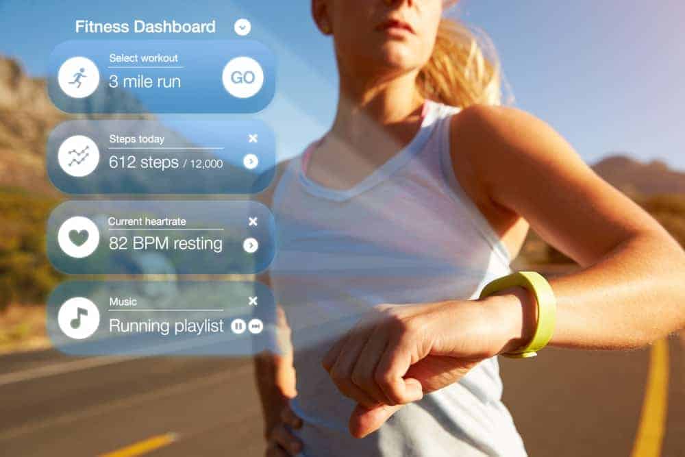 An exercising woman checking the notifications of her health tracker.