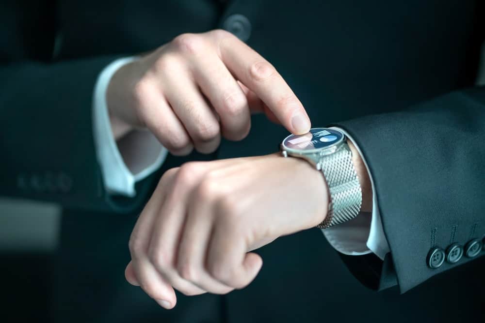 A businessman using the apps on his smartwatch.