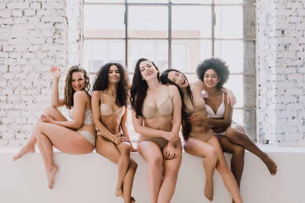A group of five women wearing lingerie.