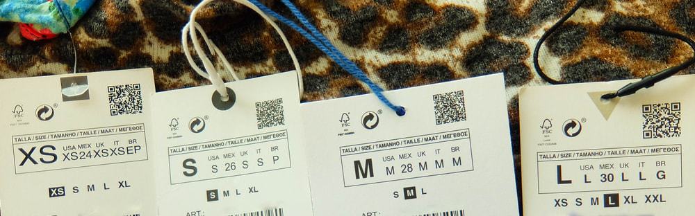 A look at sets of clothes tag labels depicting sizes.