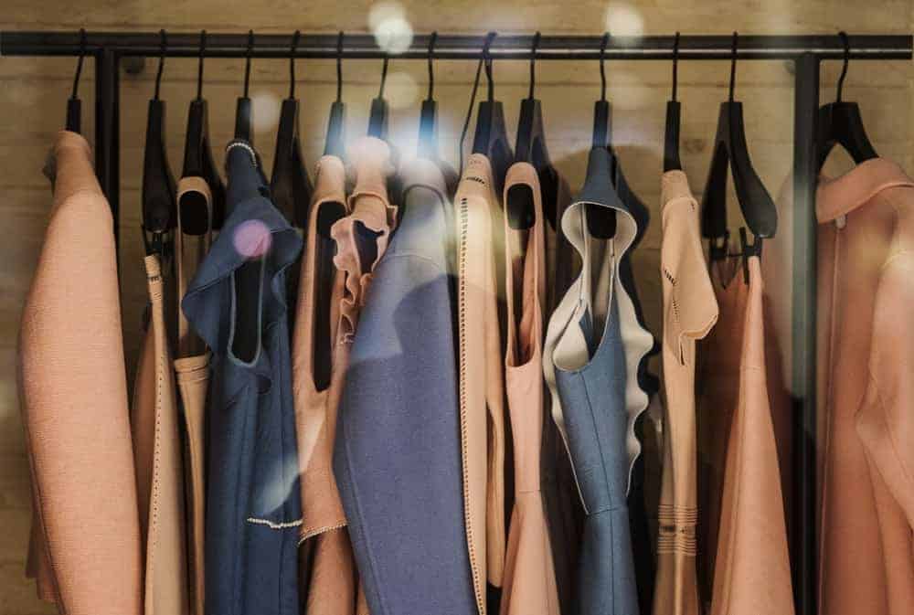 A close look at a rack of clothes in a boutique shop.