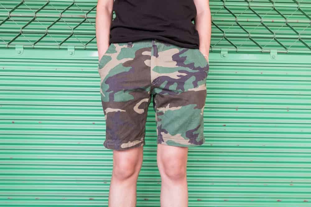 A man wearing shorts with camouflage pattern.