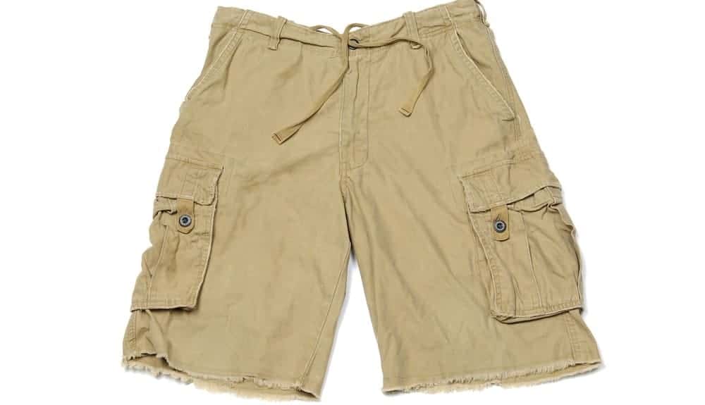 A close look at a pair of khaki cargo shorts.