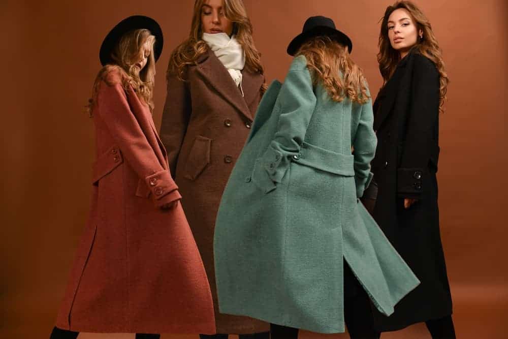 A group of women wearing different long coats.