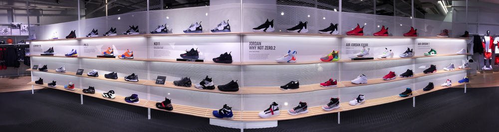 Large display of Nike sneakers and basketball shoes at the Nike Chicago Store.