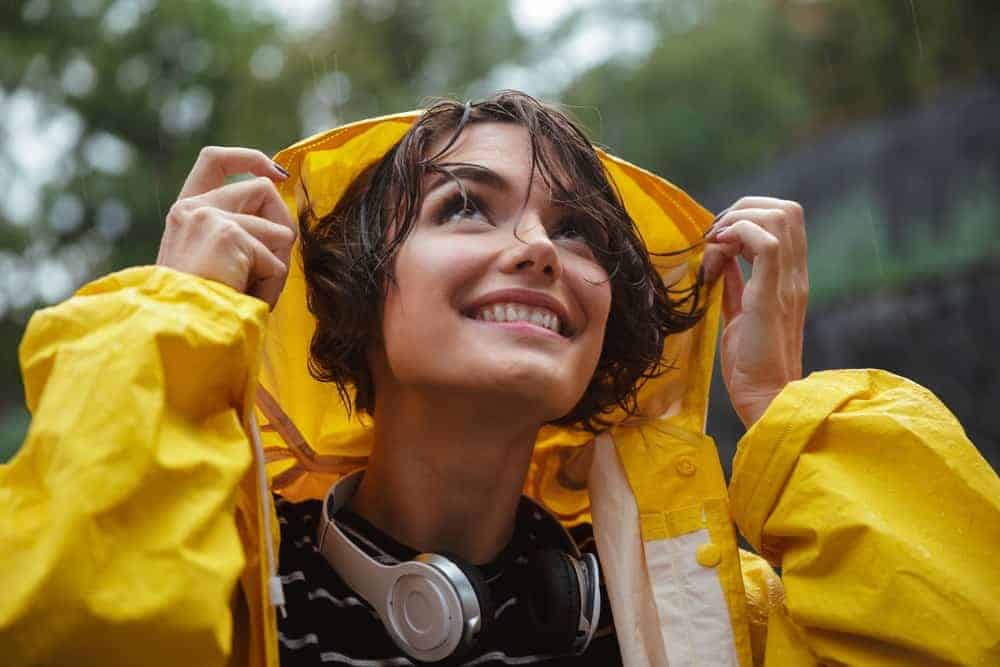 A close look at a woman wearing a raincoat.