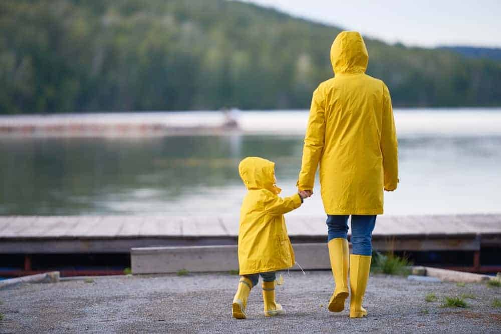 A mother and daughter wearing matching yellow raincoats.