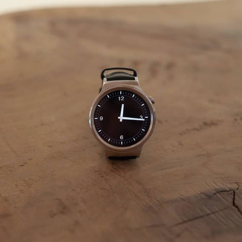 Huawei smartwatch on a wooden table.