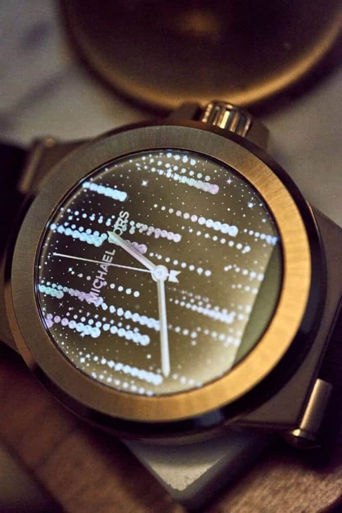 Gold Michael Kors smartwatch with future-oriented watch face design.