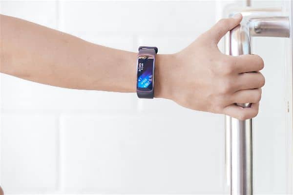 A man wearing the Samsung Gear Fit 2 Smartwatch on right wrist.