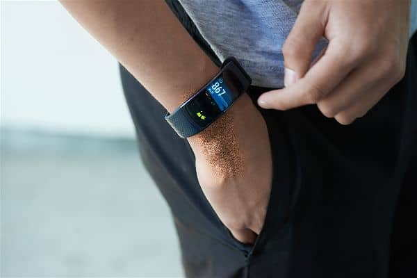A man wearing the Samsung Gear Fit 2 Smartwatch on right hand in pocket.