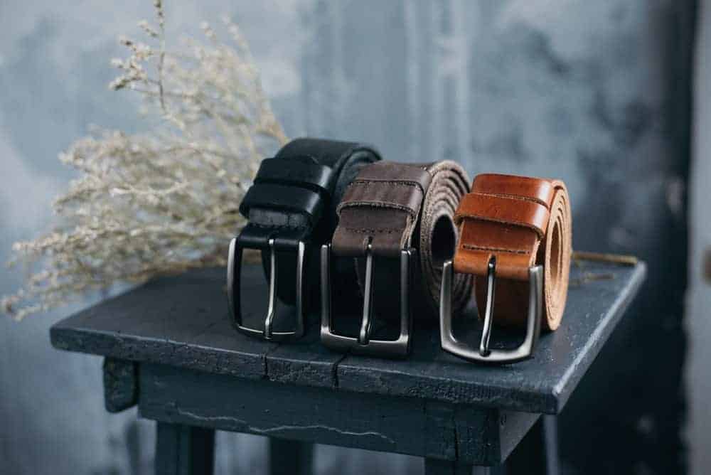 Three leather belts in various tones.