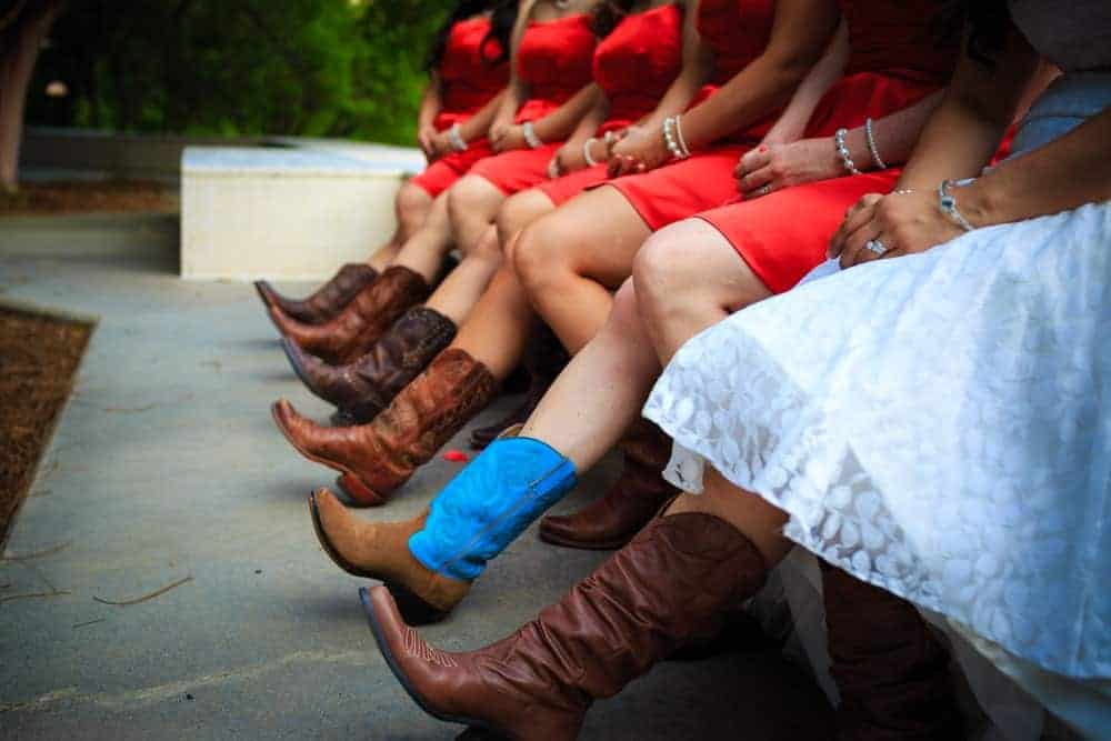 A close look at the bride and her brides maids wearing boots.