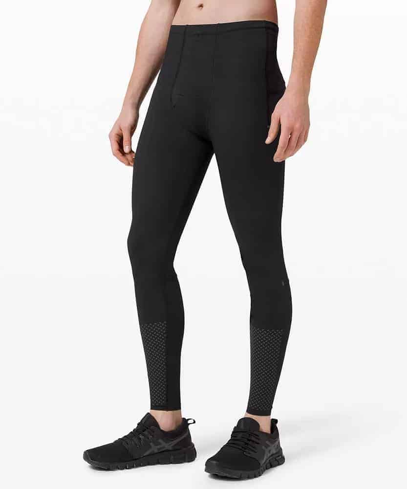 A man wearing a pair of vital drive tights from Lululemon.