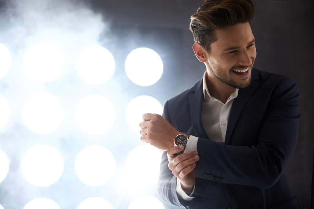 A man wearing a black modern fit suit.