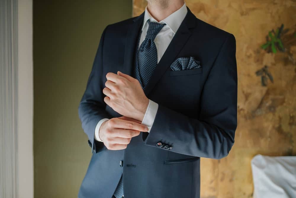 A close look at a man wearing a notch lapel suit.