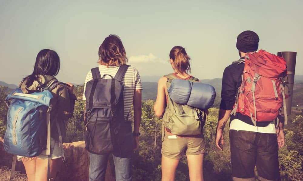 A group of friends carrying different backpacks.