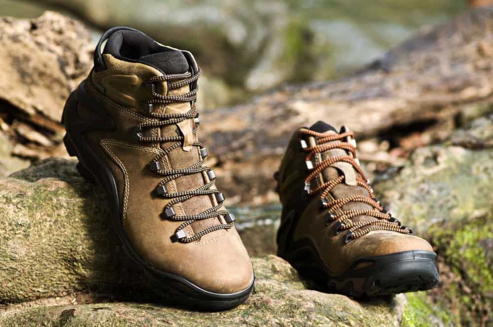 A pair of backpacking boots on a rocky terrain.