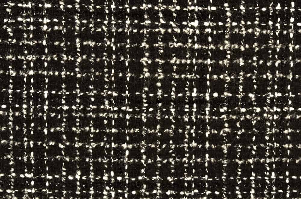 A close look at a wool black and white twill pattern.